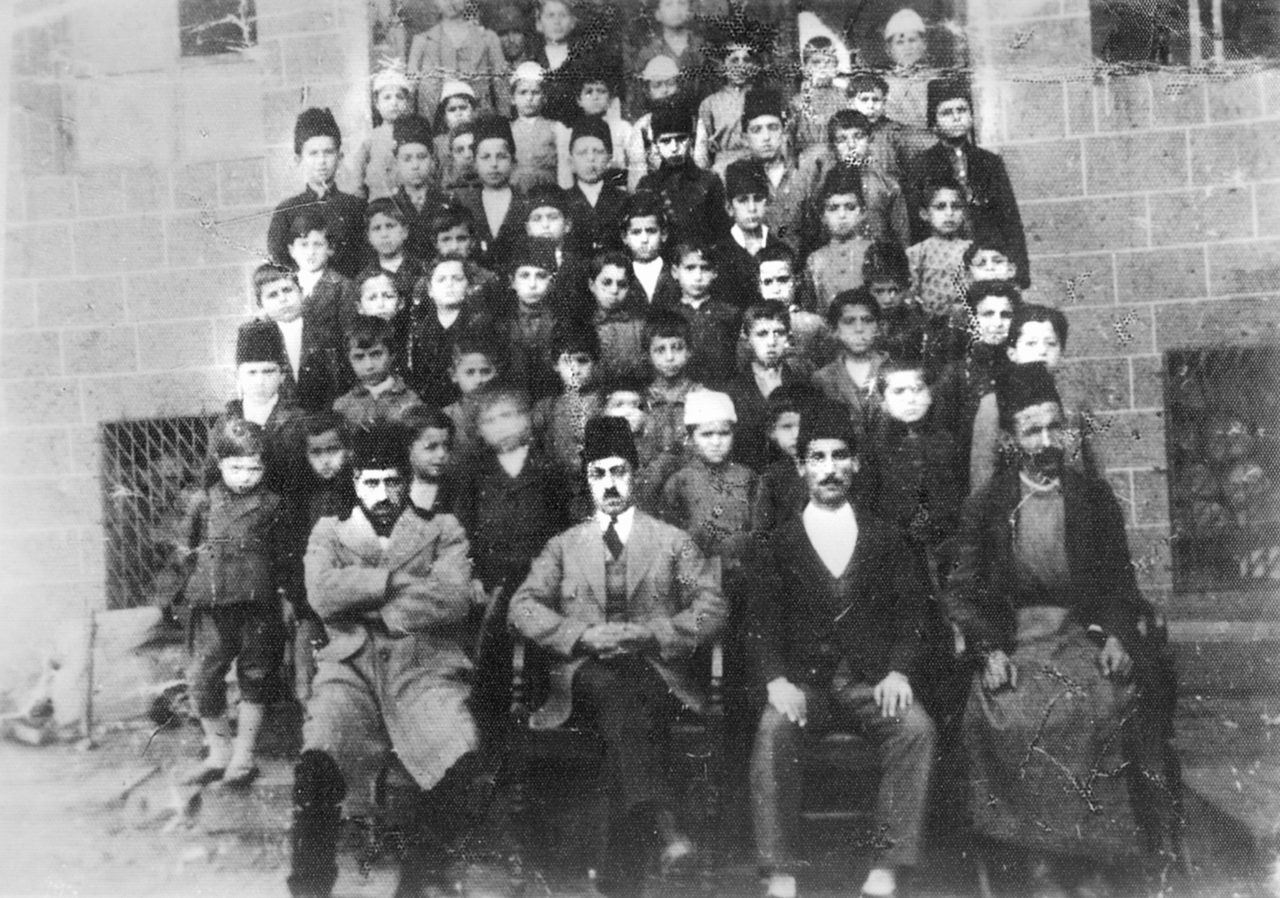 In the Syriac faith, churches are also an educational centre for the youth, and a social gathering place for believers. In this photograph taken in the late 1800s, the impatient youngsters are blurred because they moved as the photograph was being taken.<br>(The archive of Adnan Palakoğlu)