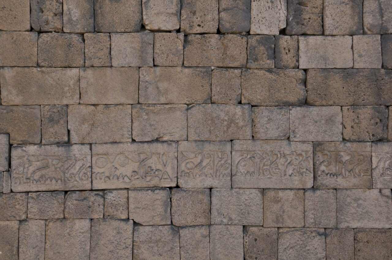 Though information about him is sparse, we know about the contributions Ahmad ibn Jamil al-Amidi, an important master of Anatolian Islamic architecture, made to the Diyarbakır city walls from this inscription at Mardin Gate dated 909 (297 AH):<br>“In the name of God, the merciful and the compassionate. This is what has been commissioned by the ruler of believers, Imam Abd Allah Ja’far al-Muqtadir Bi-llah –may God grant him long life and glory– in order to exalt our religion and protect Muslims. It has been executed by Vizier Ali son of Abu al-Hasan Muhammad –may God grant him long life–. Expenditures for this structure have been made in the custody of Yahya son of Ishaq of Jarjara and Ahmad son of Jamil of Amid in the year 297.”<br>(Photograph: Merthan Anık, 2009)